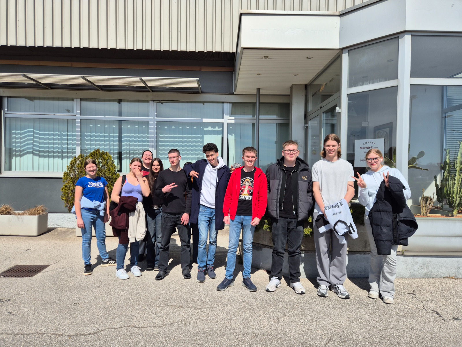 Exkursion_Schärf 1 Gruppenfoto von Schüler:innen vor dem Gebäude der Firma Schärf in Wiener Neustadt.